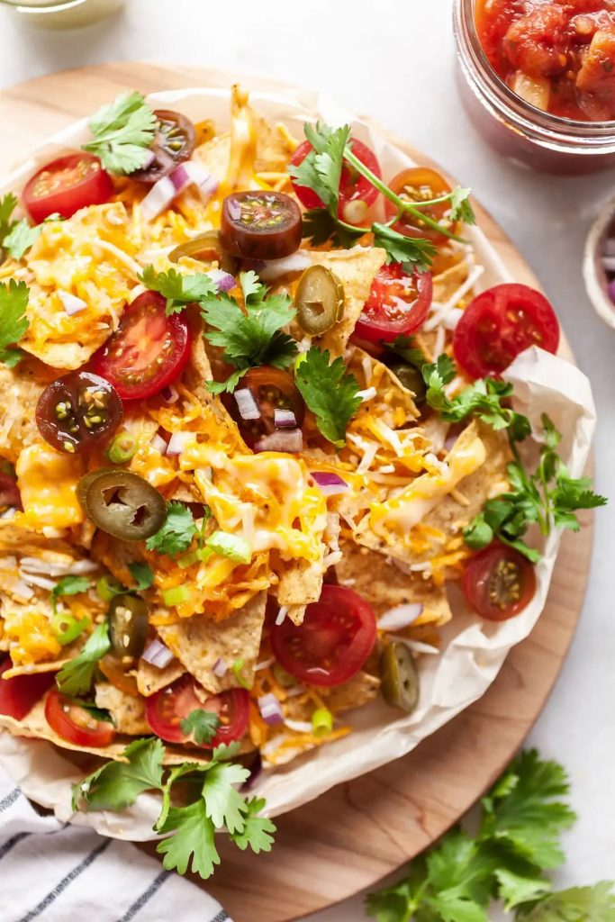 Nachos smothered with cheese and sliced toppings