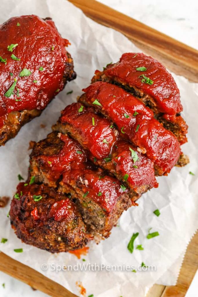 Sliced Meatloaf on backing paper and wooden tray