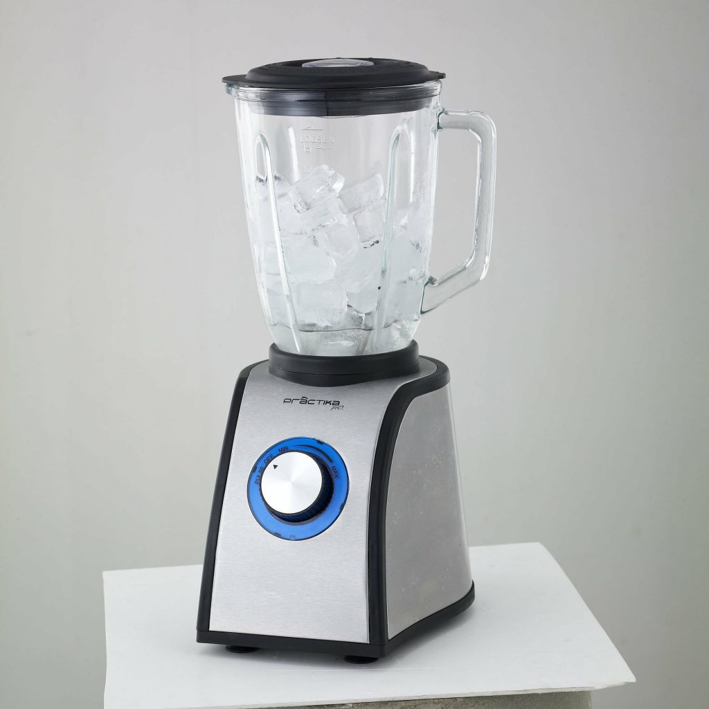Silver blender with a blur dial. The jar is full of ice cubes.