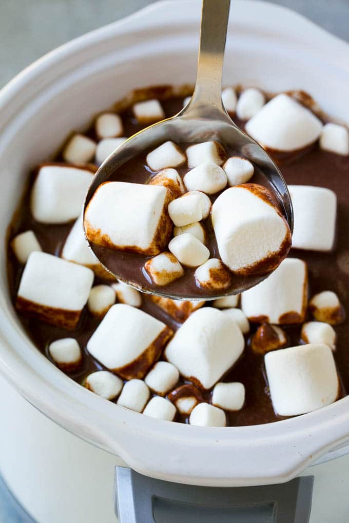 Thick hot chocolate cooked in a slow cooker with lots of marshmallows on top