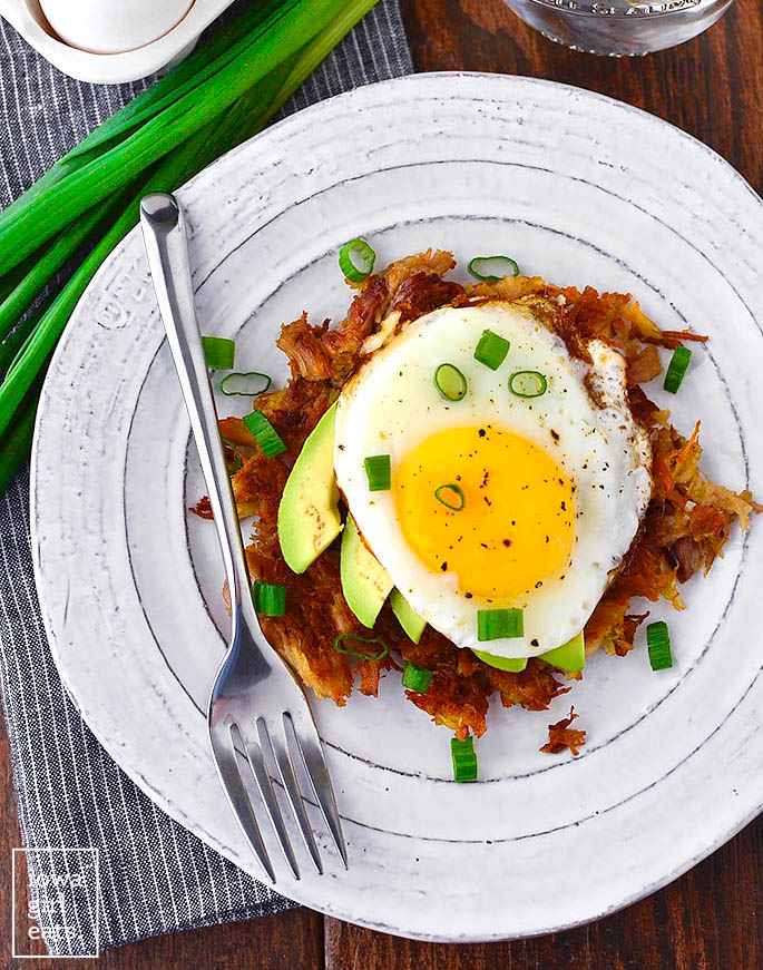 Meat with avocado and fried egg on top