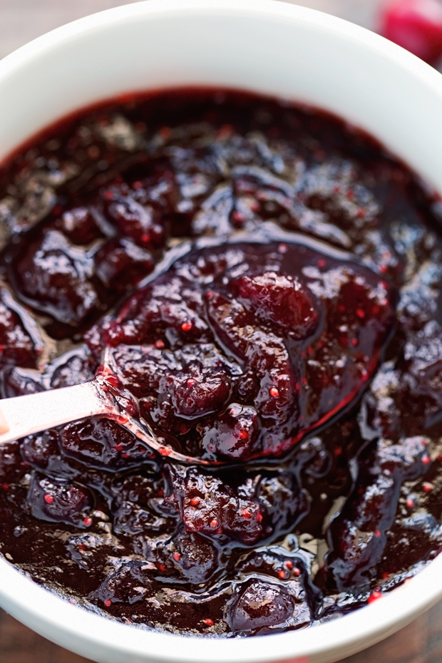 Slow cooked cranberry sauce in white bowl