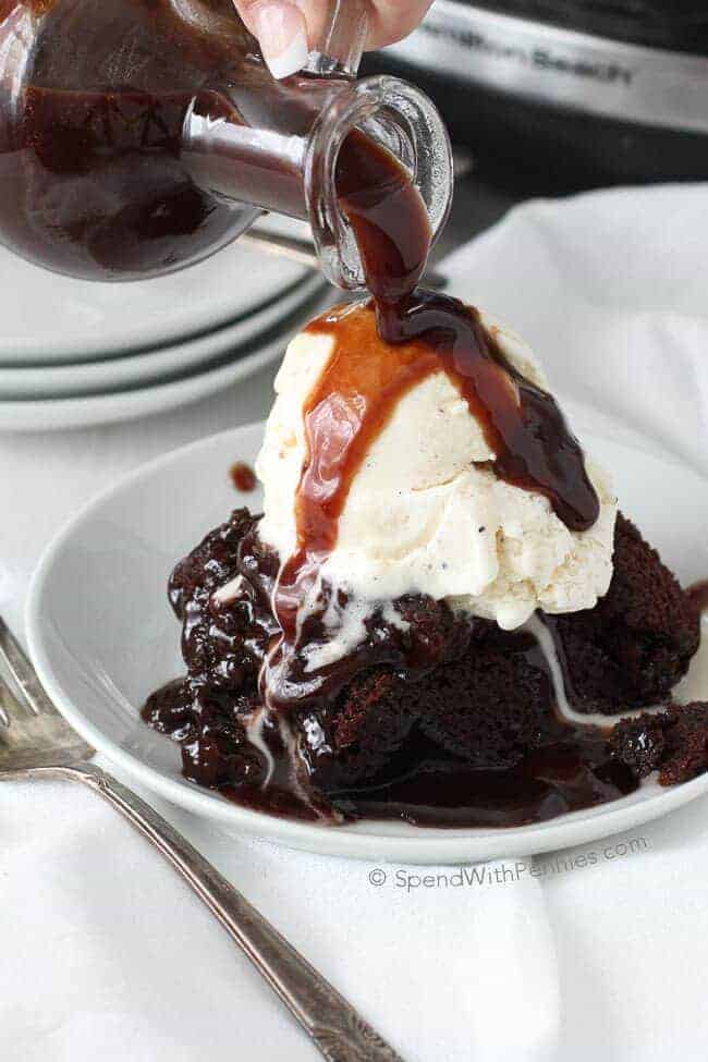Rich brownie dessert covered with ice cream and chocolate sauce