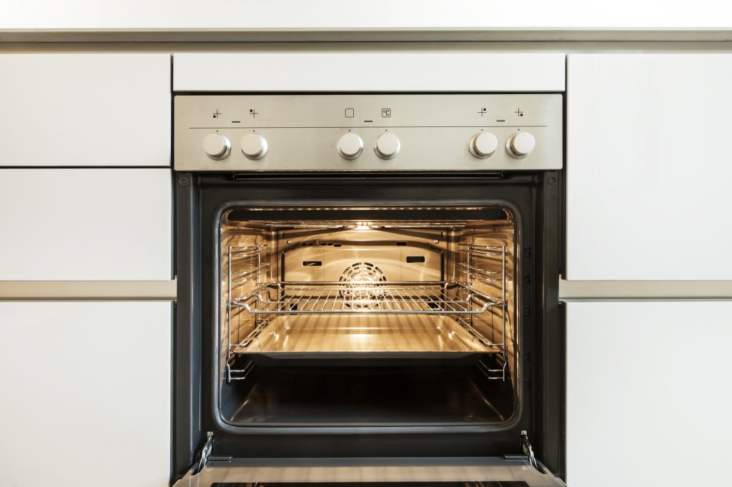 Clean interior of oven in modern white kitchen