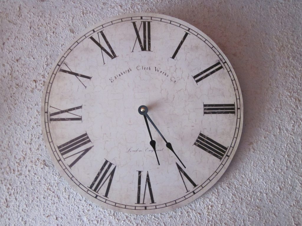 Large wall old-fashioned wall clock with roman numerals